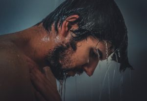 man with wet hair in shower