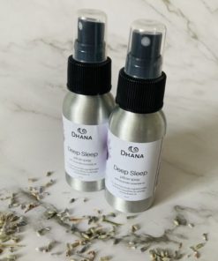 aluminum bottles of deep sleep pillow spray with lavender and marble background