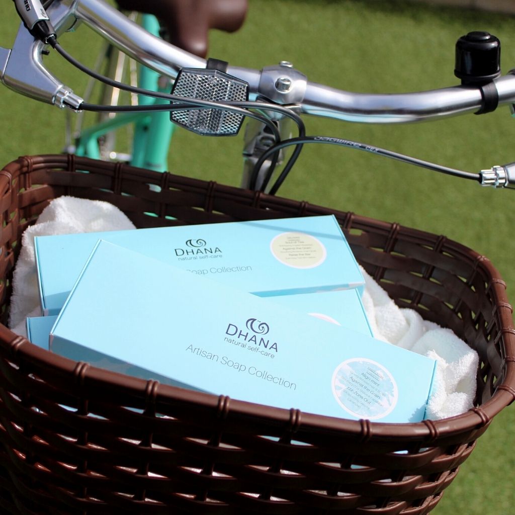 Turquoise soap collections in the basket of a green bike