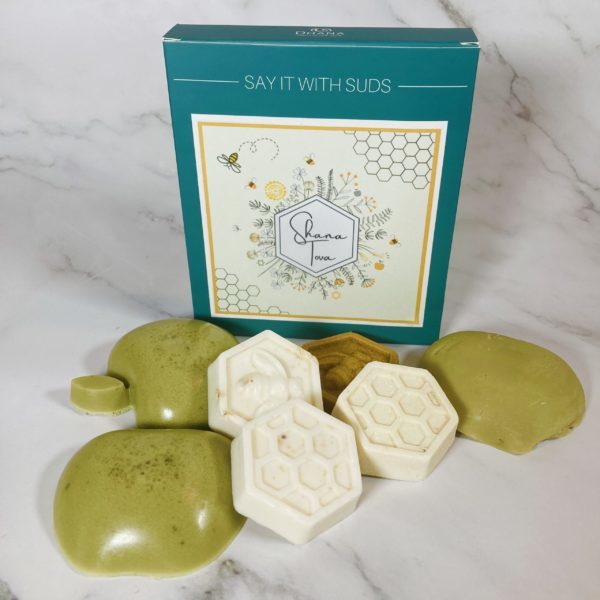 green box with apples and honey soaps in front