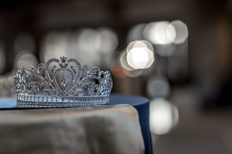 sparkly woman's tiara crown on table with blurred out lights in background