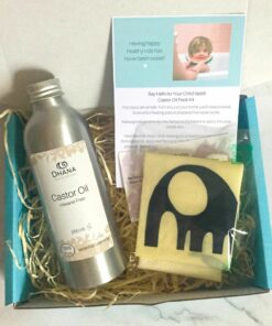 Children's Castor Oil Pack Kit (contains aluminium bottle of oil, instructions, elephant oil protector on top of cotton flannel, with instructions all in turquoise box on marble background.)