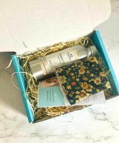 Children's Castor Oil Pack Kit (contains aluminium bottle of oil, instructions, flower protector on top of flannel all in turquoise box on marble background.)