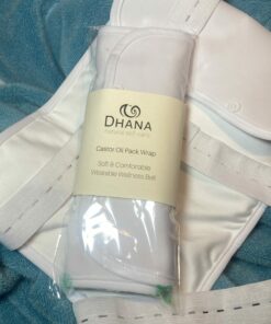 Dhana Self-Care Castor Oil Wrap in package on top of one laid out on a turquoise towel